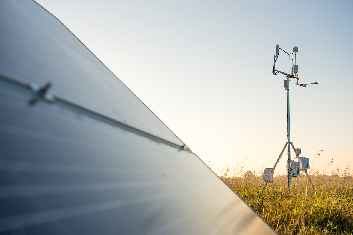 A solar-powered eddy covariance system deployed in open grassland taking greenhouse gas measurements.